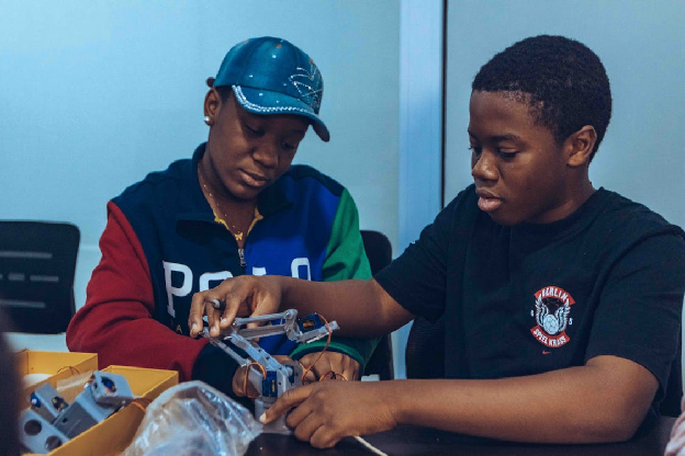 Children collaborating on robotics and game development